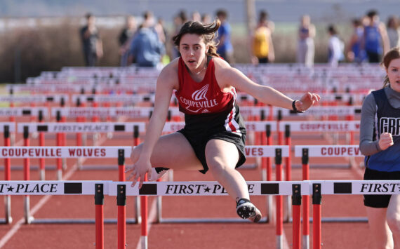 Photo by John Fisken
Freshman Liza Zustiak runs in a hurdle event March 22 during Coupeville High School's first home track and field meet of the season. Zustiak competed in the 100 meter hurdles and 300 meter hurdles, winning 9th place in both events and earning a personal record of 23.56 seconds in the 100 meter hurdles race.