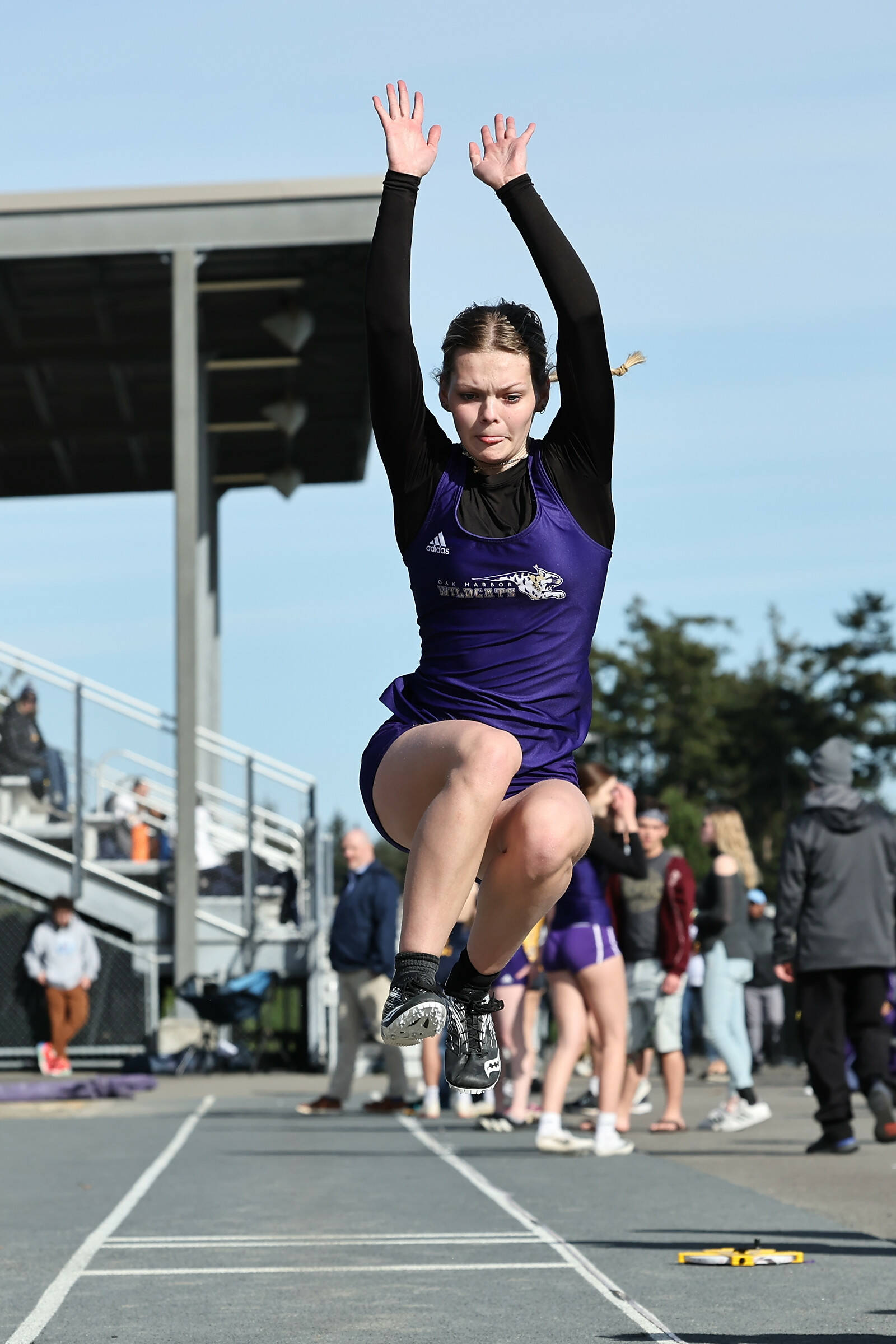 Verity Merth lands a jump at a March 19 track meet against Burlington. The Oak Harbor High School varsity girls team won 96.83 to 53.16. (Photo by John Fisken)
