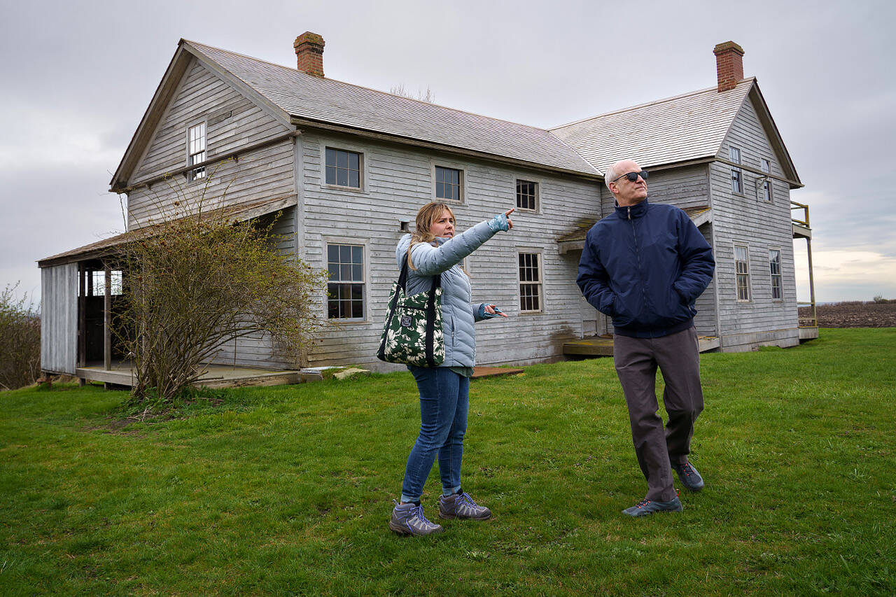 Ebey’s Landing National Historical Reserve manager Marie Shimada shows Rep. Rick Larsen around the historic Coupeville Ferry House property during a visit to the island April 6. (Photo by David Welton)