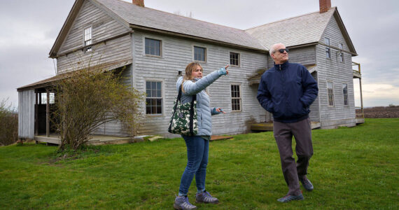 Photo by David Welton
Ebey's Landing National Historical Reserve manager Marie Shimada shows Rep. Rick Larsen around the historic Coupeville Ferry House property during a visit to the island April 6.