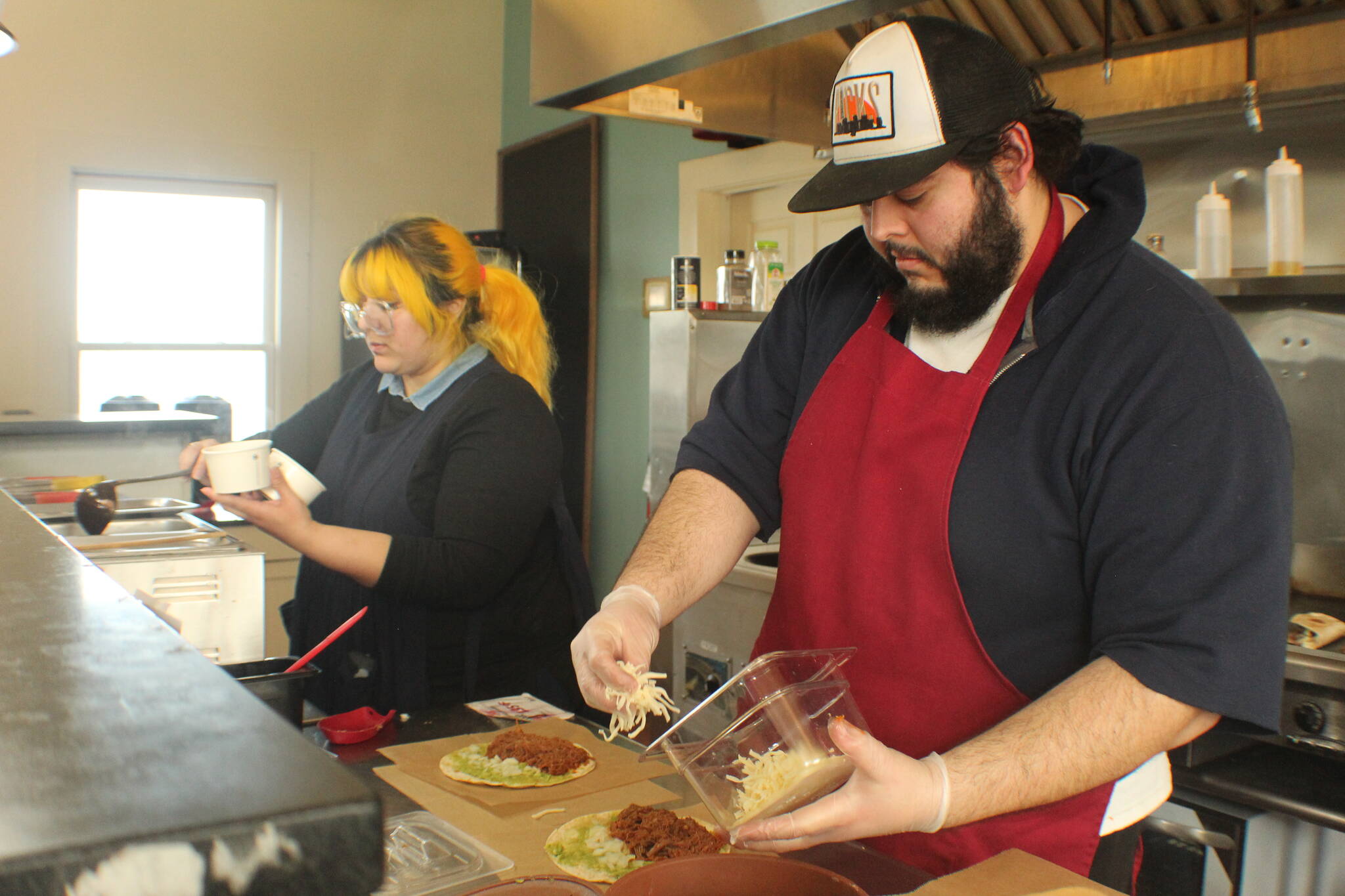 Veronica and Mario Saenz prepare food at their newly reopened Mexican restaurant, Molka Xete. (Photo by Karina Andrew/Whidbey News-Times)