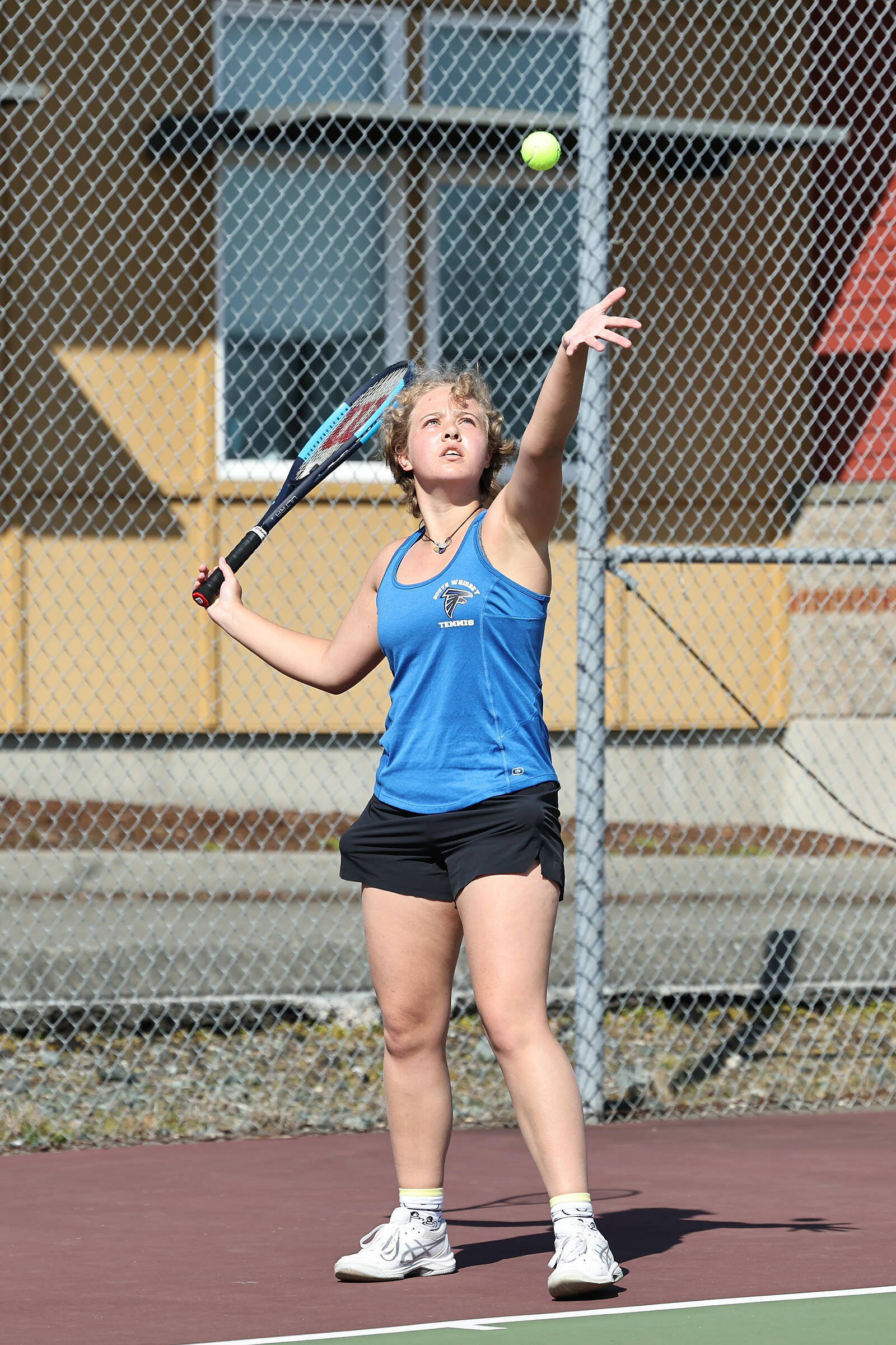 Photo by John Fisken
Junior Catie Beech of South Whidbey serves the ball during a tennis match against Coupeville on April 14. Coach Karyle Kramer said it was Beech’s first time playing singles this year and her match was the highlight of the day. Even though she lost 4-6, 6-7, Beech showed mental and physical toughness. Kramer said she worked on implementing strategies and tactics and made progress even during the match. “I’m proud of her for persevering and not giving up,” Kramer said.