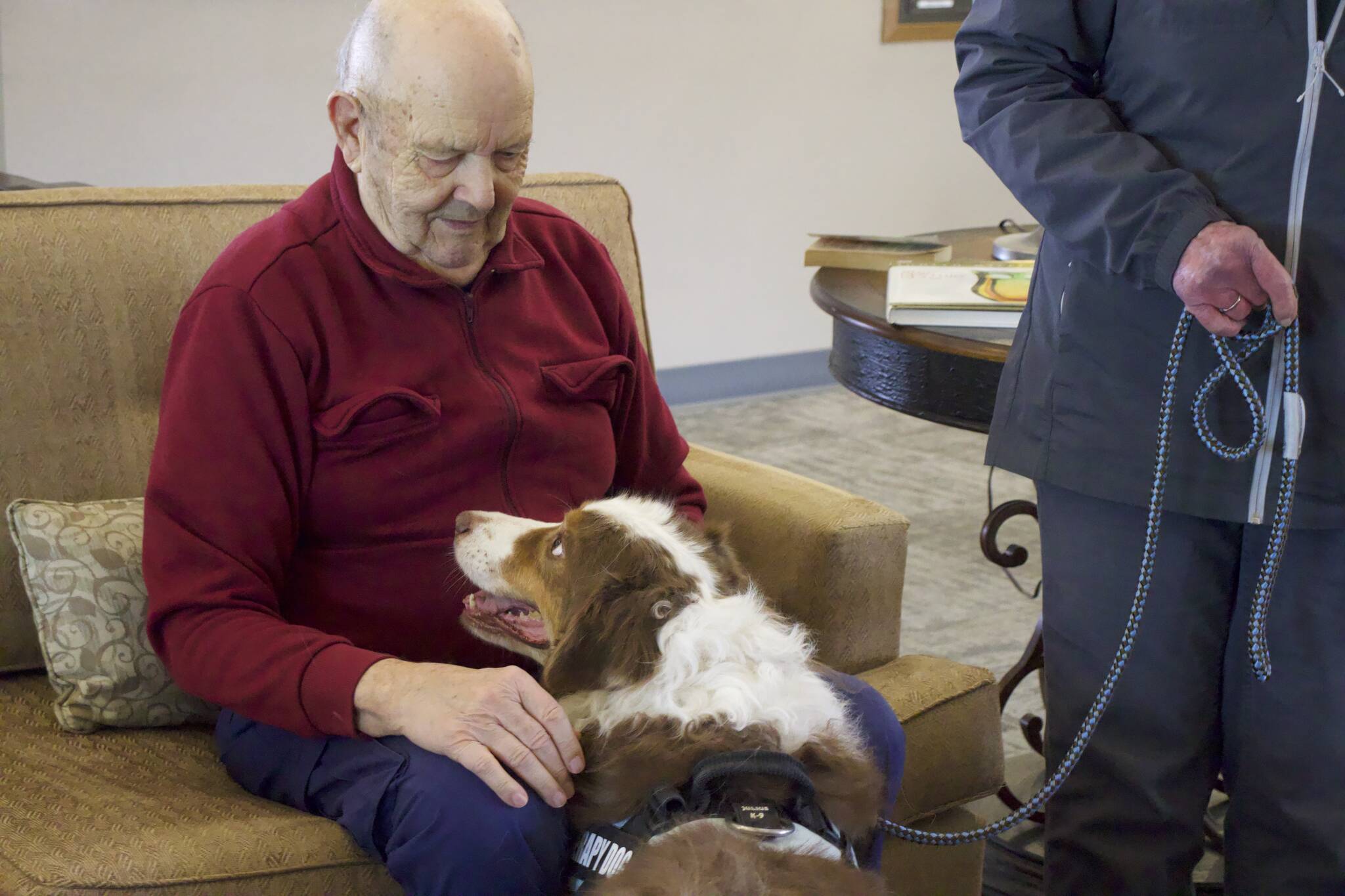 Art Mittlieder, a resident at Harbor Tower Village, spends time with a therapy dog named Dillon.