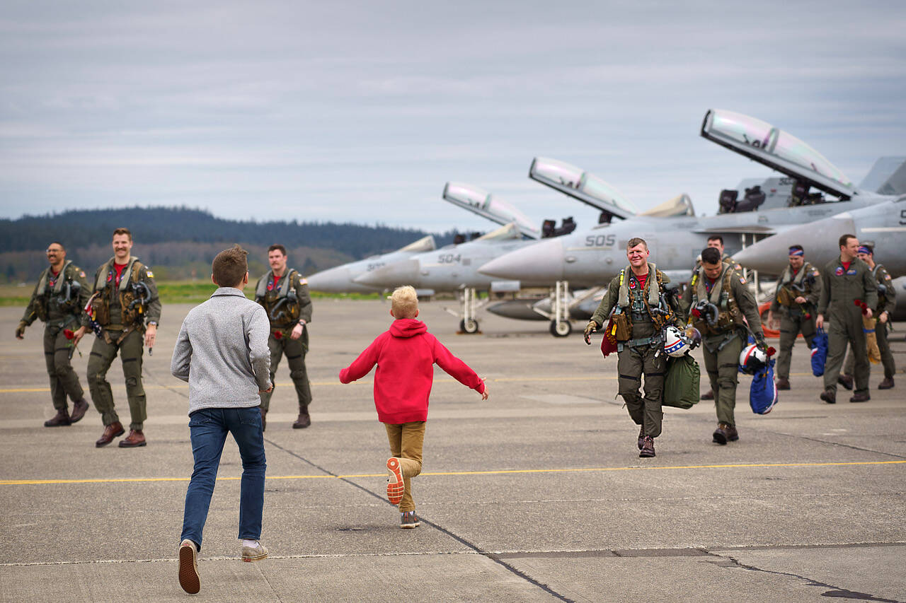 Capt. Erik Halvorson’s sons greet him on the flight line as he and his squadron return home from deployment April 22.