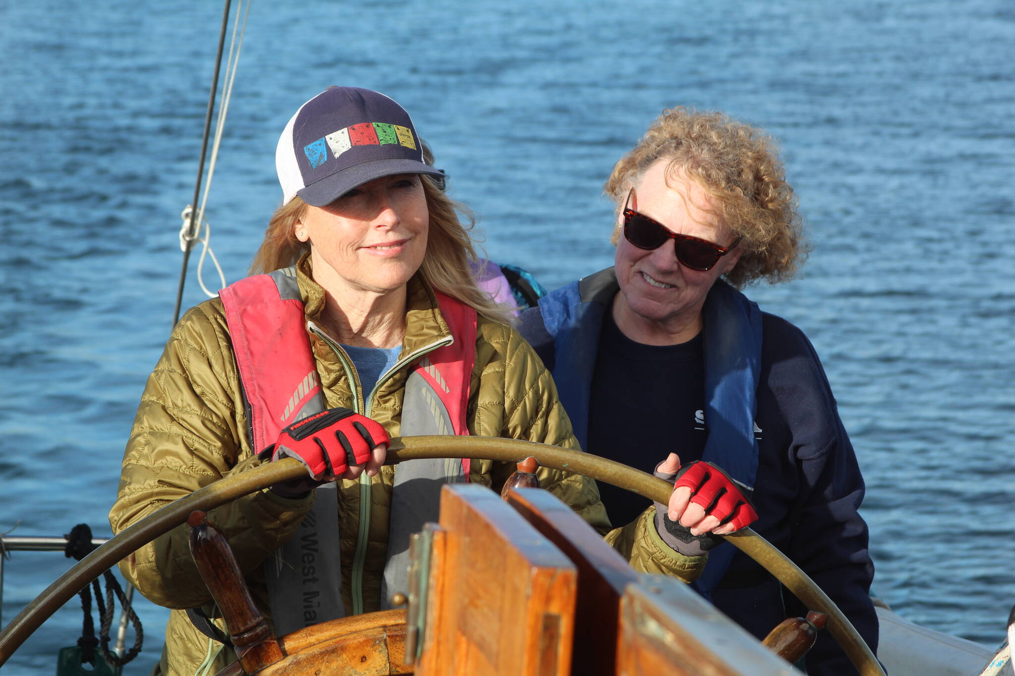 Francesca Russo, left, and Martha Ford steer the Suva during a crew training sail Monday evening. (Photo by Karina Andrew/Whidbey News-Times)