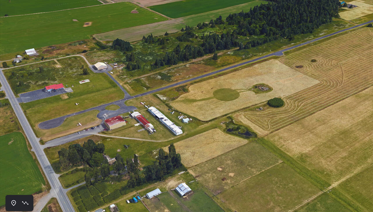 A Google Earth image shows the buildings and the runway at the small airport near Oak Harbor.