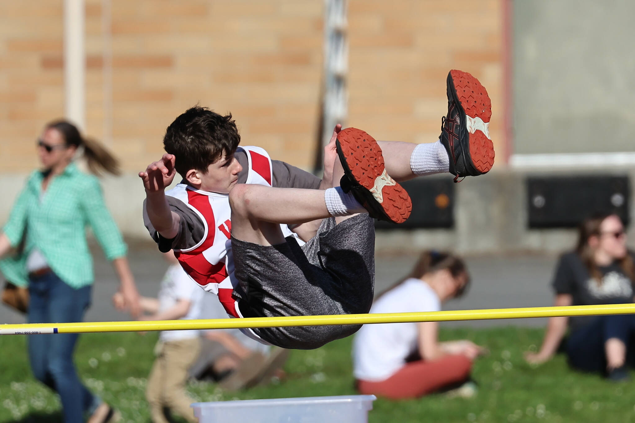 Seventh grader Johnathan Jacobsen competes in the high jump. (Photo by John Fisken)