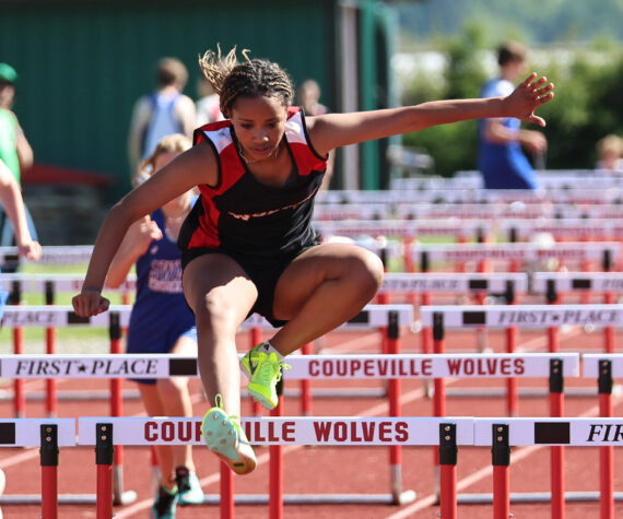 Photo by John Fisken
Seventh grader Arianna Cunningham leaps over a hurdle at a track meet against South Whidbey Middle School Wednesday.