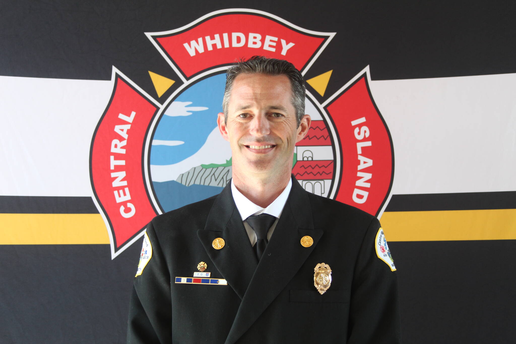 Longtime Central Whidbey Island Fire and Rescue firefighter Jerry Helm was sworn in as chief for the district at the fire station in Greenbank May 16. (Photo by Karina Andrew/Whidbey News-Times)