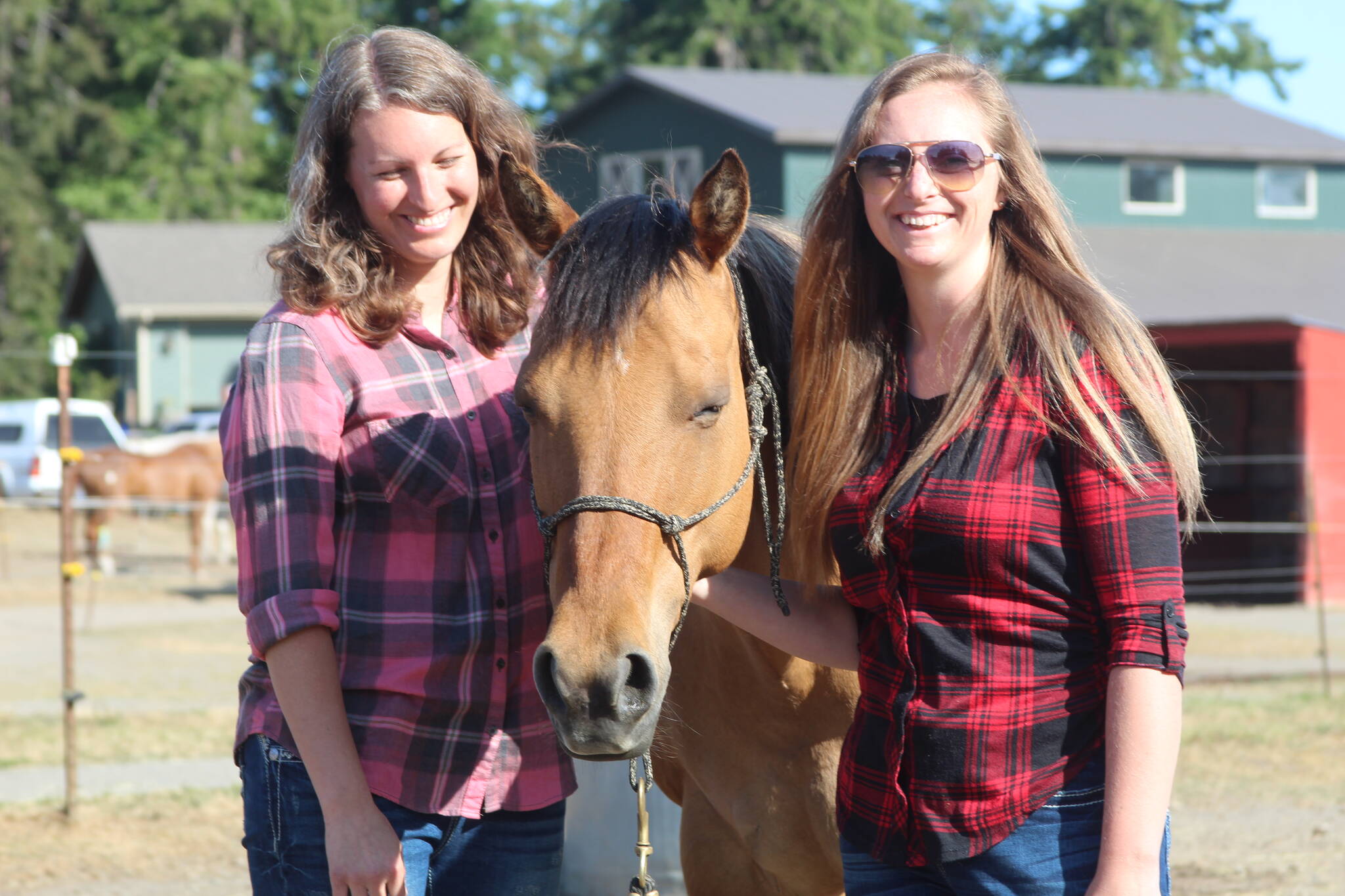 Jaimie Sawyer, left, and Shannon Ivins stand with Apache.