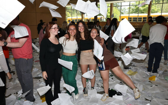 Photo by John Fisken
In an annual Paper Toss tradition, graduating seniors at Oak Harbor High School joyously threw hundreds of pages of homework into the air. The graduation ceremony is Saturday.