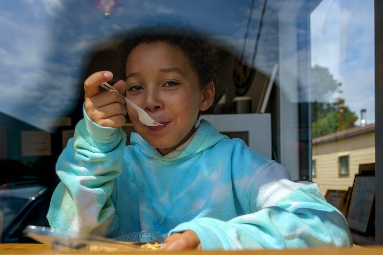 Thebe Madi, 9, digs into a piece of pie. (Photo by David Welton)