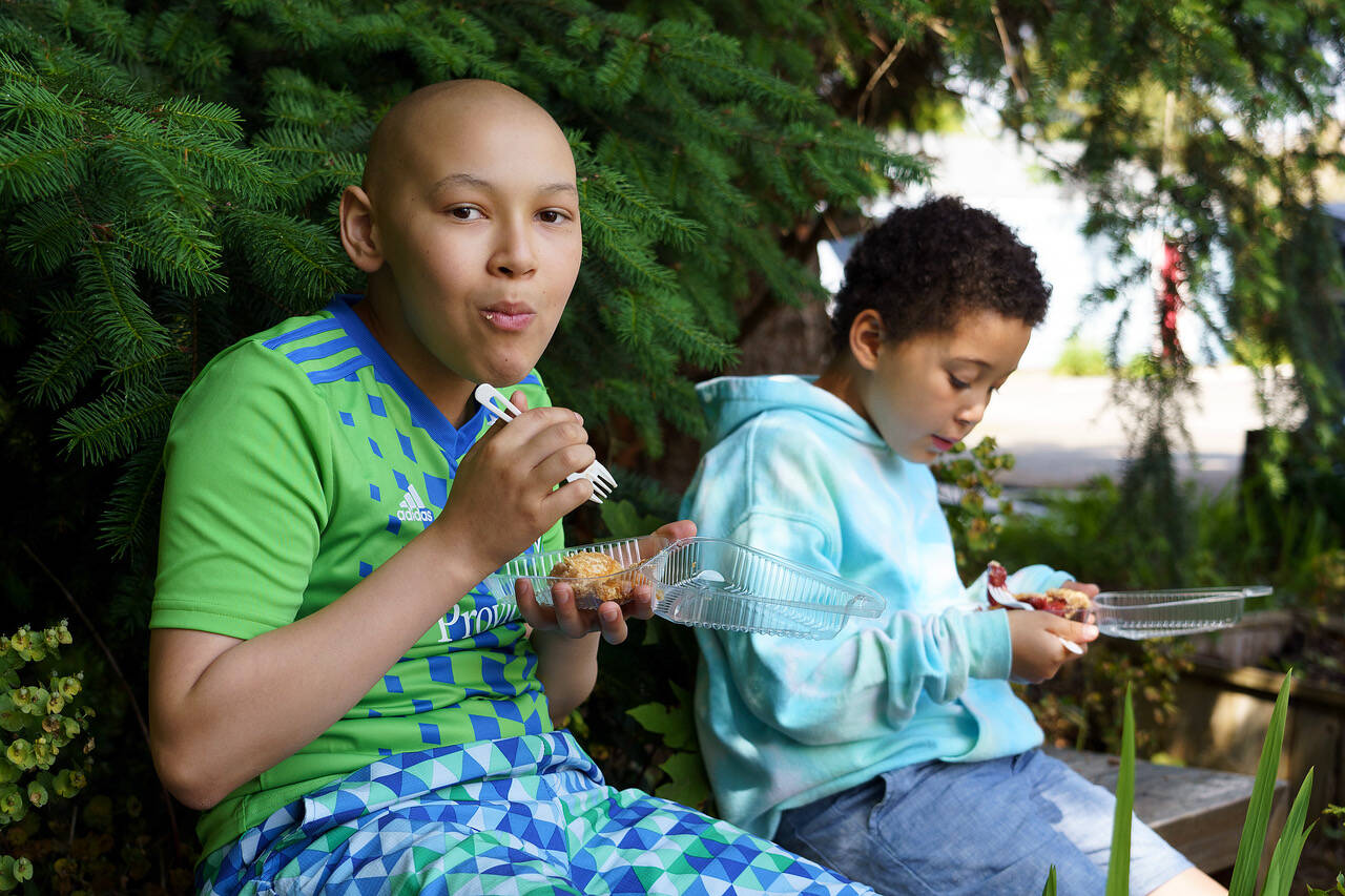 James Madi, 12, and Thebe Madi, 9, try some dessert from Whidbey Pies. (Photo by David Welton)