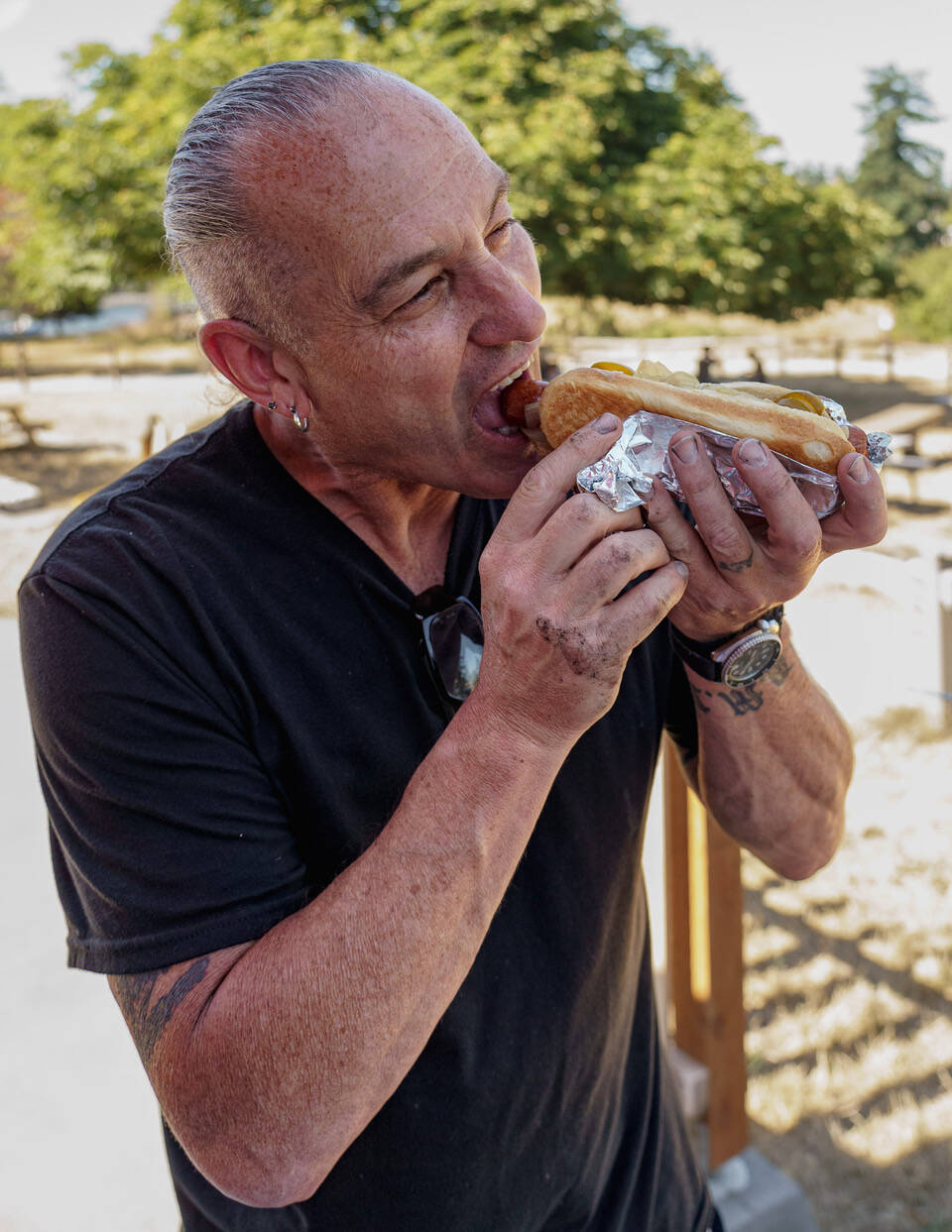 An employee of Penn Cove Brewing Company enjoys a hot dog. (Photo by David Welton)