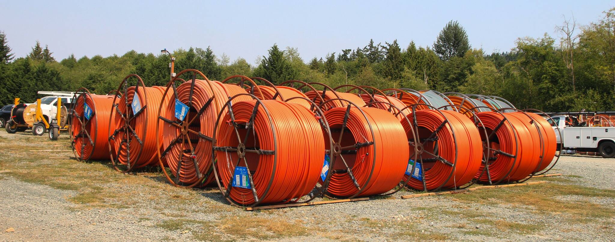 These orange rolled pipes, located at the Whidbey Telecom construction staging area in Langley, are conduits containing smaller tubes through which the fibers are pulled. They will be buried underground, on land. (Photo by Luisa Loi/Whidbey News-Times)