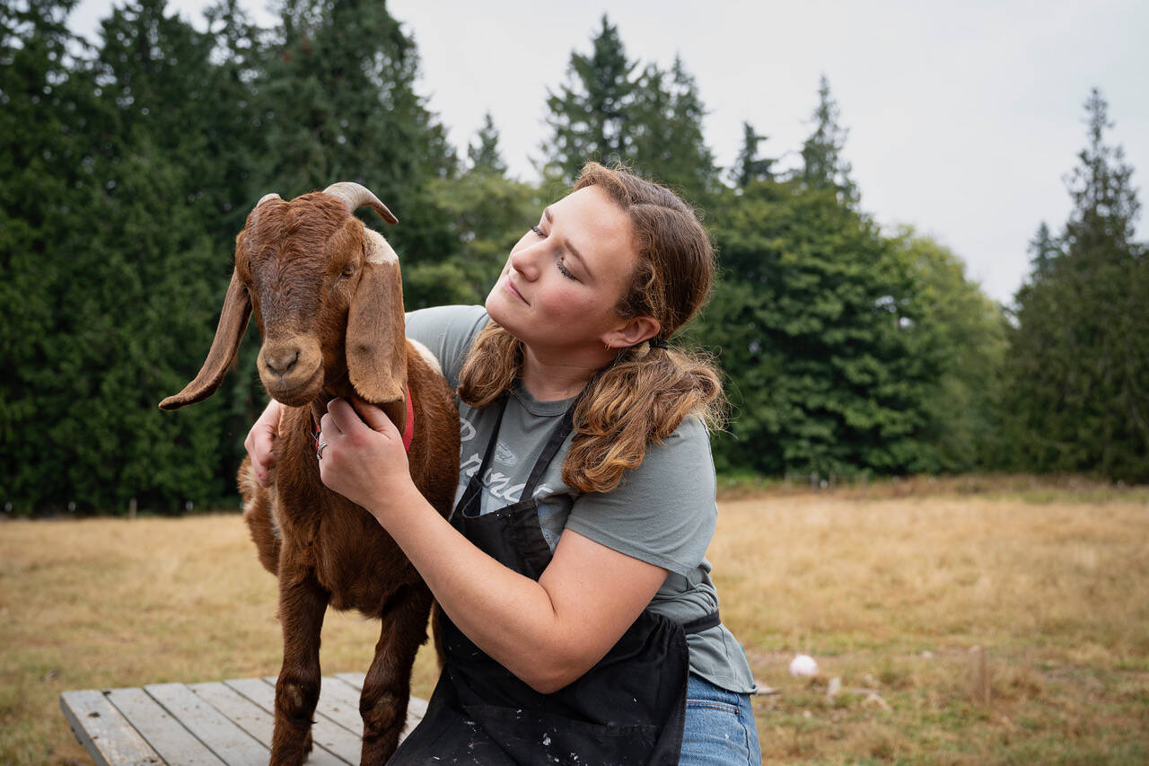 Photo by David Welton Sarah Santosa with Peter the Goat.