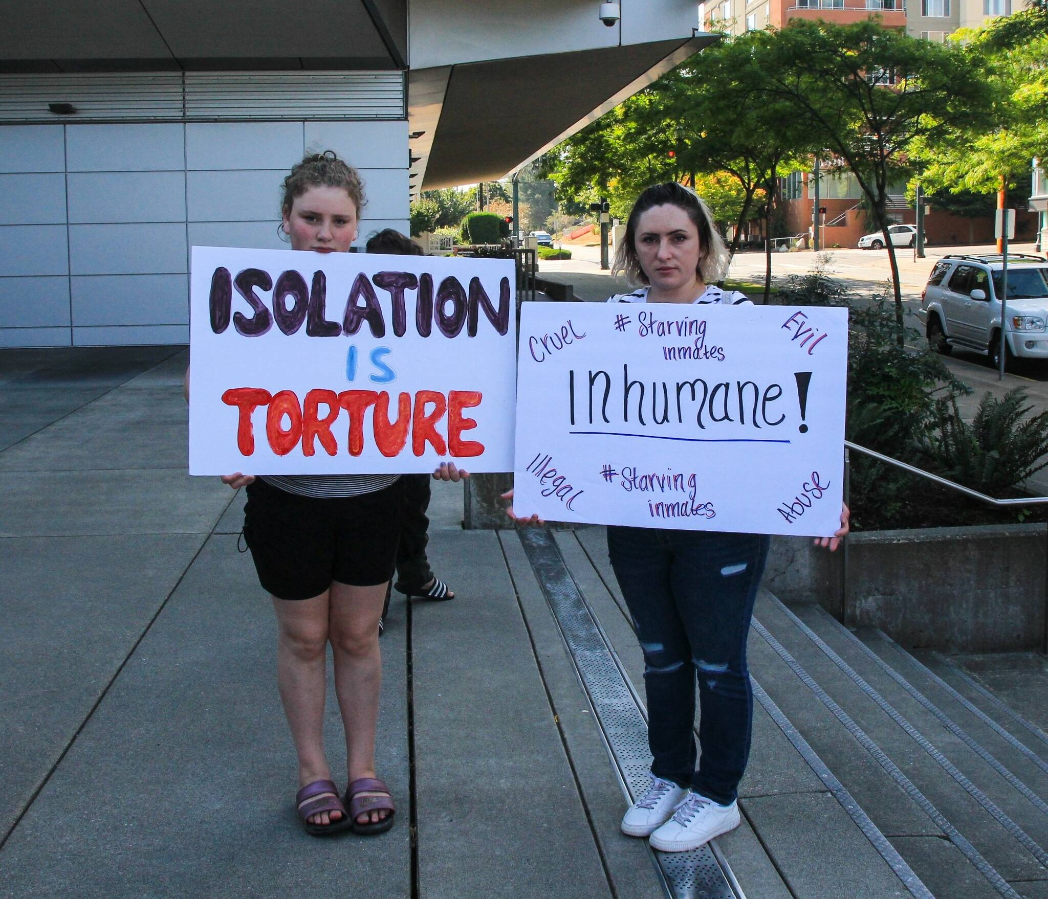 Photo by Luisa Loi/Whidbey News-Times 
Protesters stand in front of the Snohomish County Corrections building with signs.