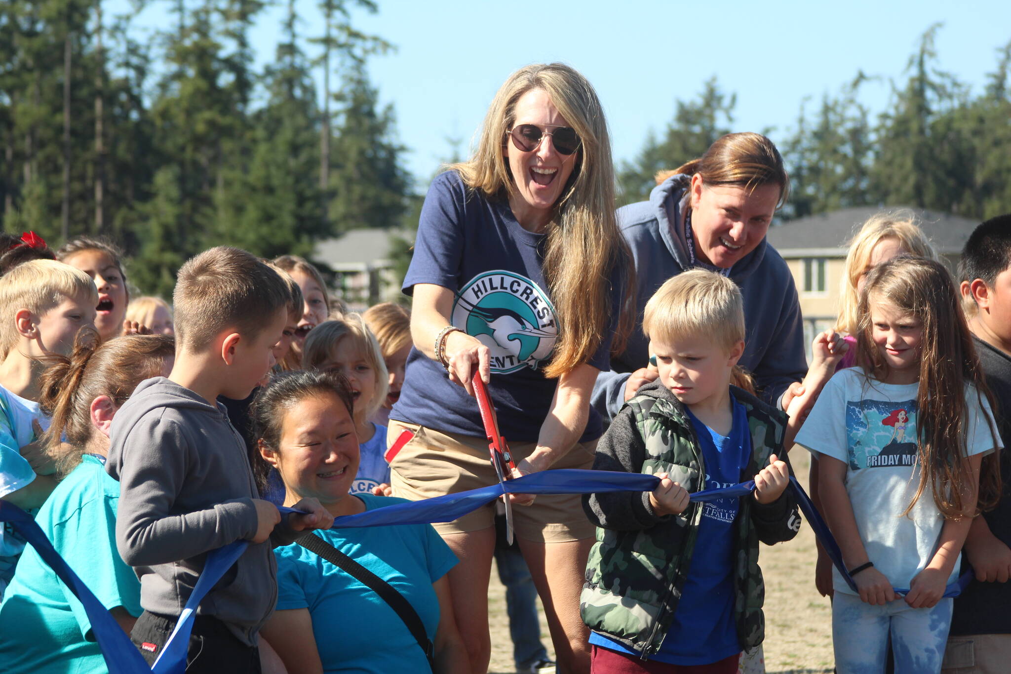 Photo by Karina Andrew/Whidbey News-Times
Hillcrest Elementary School President Samantha Horrobin cuts the ribbon at the opening of the newly paved walking path Sept. 15.