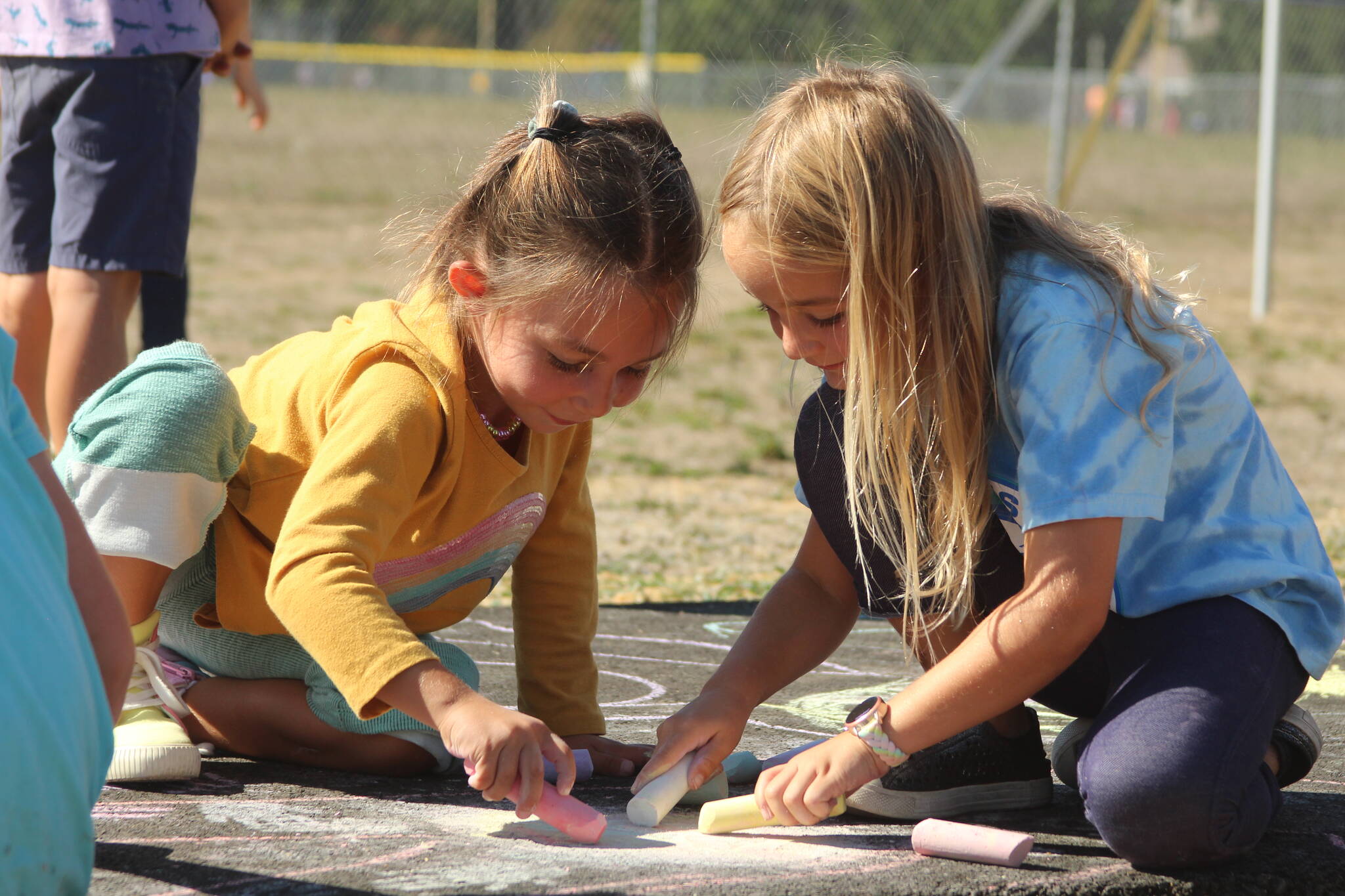 Photo by Karina Andrew/Whidbey News-Times
First graders Isla Stewart, left, and Millie Kindred help “chalk the walk” Sept. 15 at Hillcrest Elementary School.