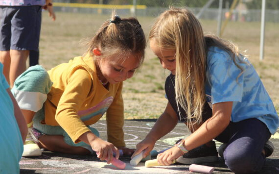 Photo by Karina Andrew/Whidbey News-Times
First graders Isla Stewart, left, and Millie Kindred help "chalk the walk" Sept. 15 at Hillcrest Elementary School.