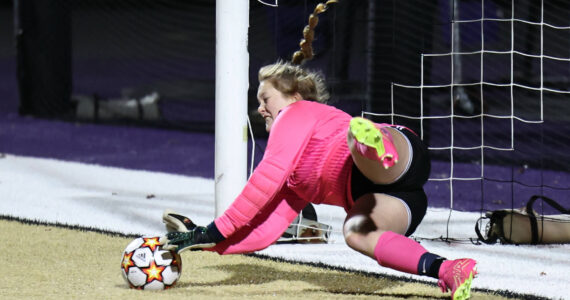 Oak Harbor High School goalkeeper Lauren Marrs blocks a shot
Oct. 26 during a play-in game against Arlington. The game went to penalty kicks
where Oak Harbor won. Photo by John Fisken.