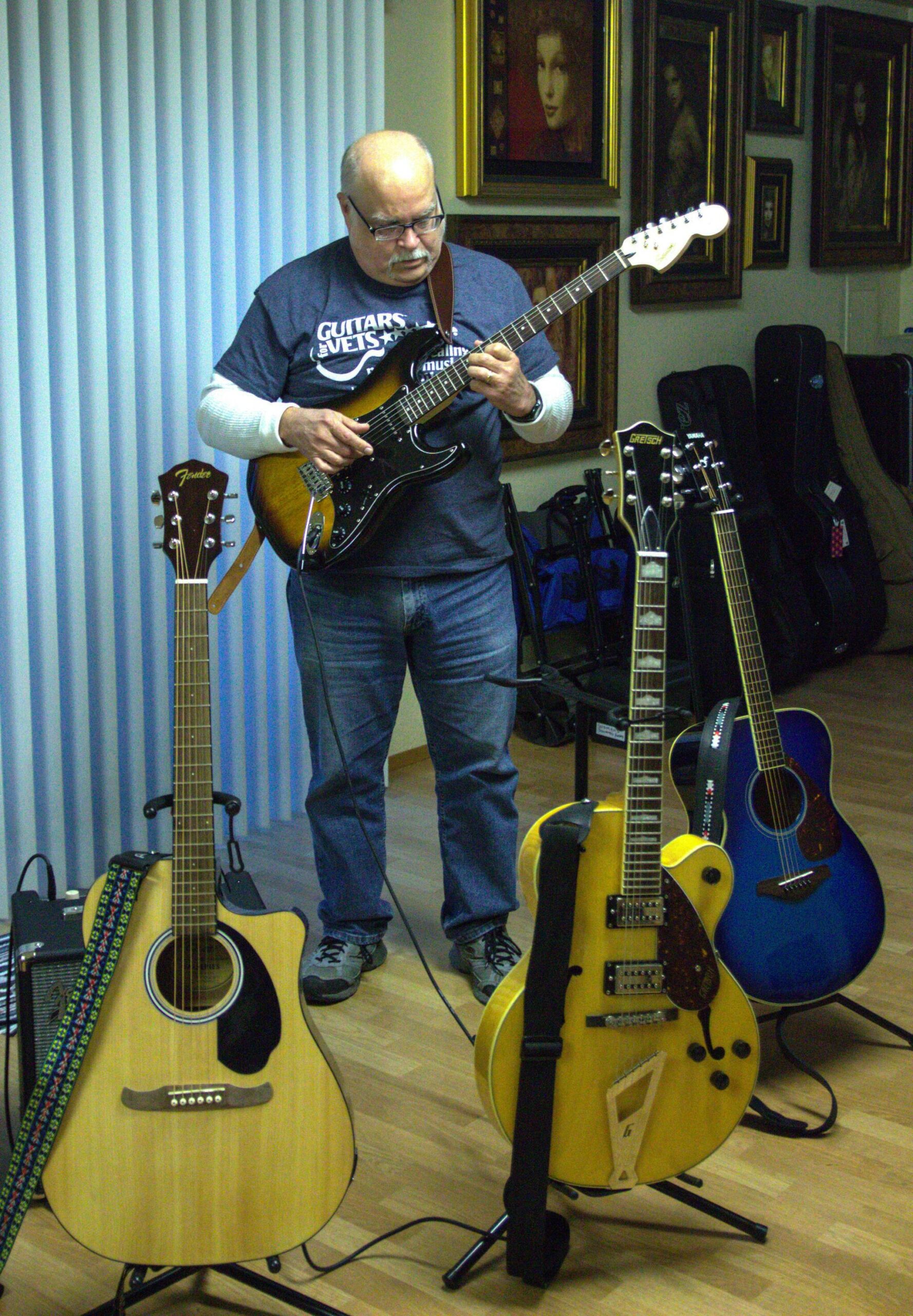 Gary Raster shows some of his guitars at his house. (Photo by Luisa Loi)