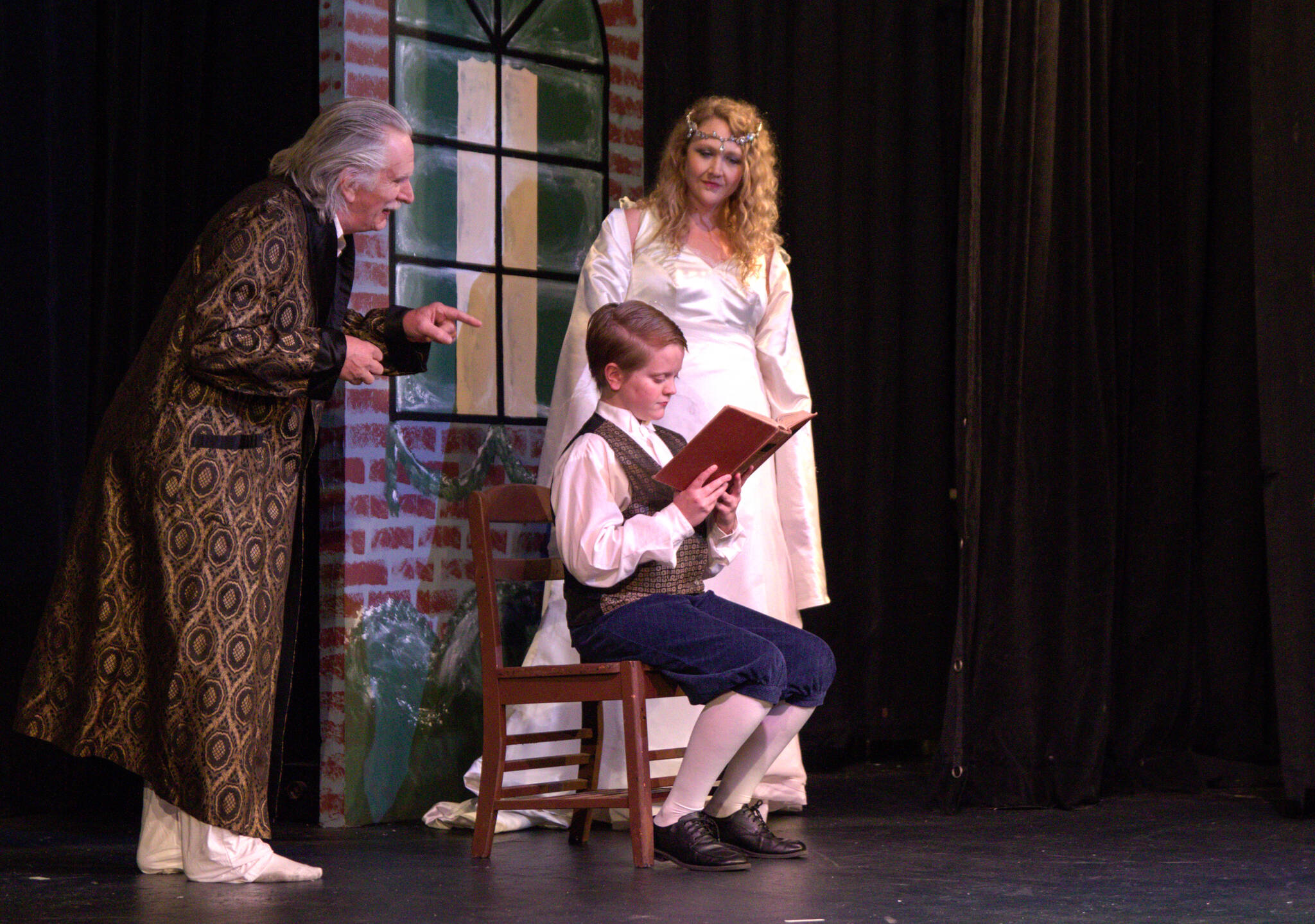 The Ghost of Christmas Past (Amy Jones) takes Scrooge (Ben Honeycutt) back to his childhood. (Photo by Luisa Loi)