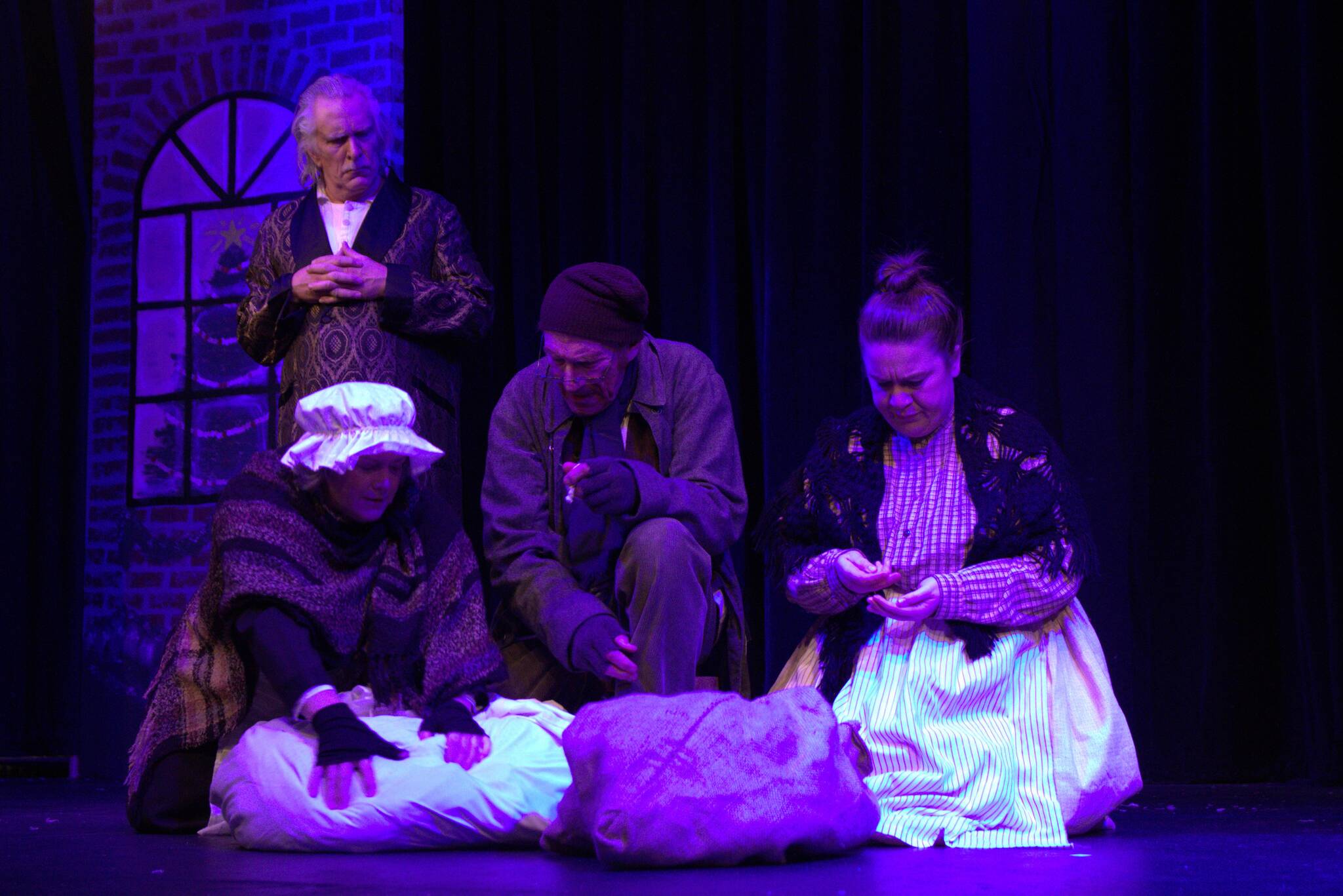 Scrooge (Ben Honeycutt) sees what would happen after his passing if he does not change his attitude. (Photo by Luisa Loi)