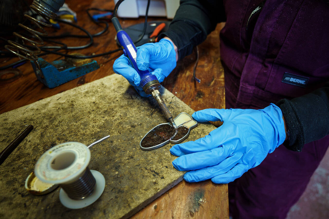 Mackensie Bennett solders a glass morel mushroom in her workshop. (Photo by David Welton)