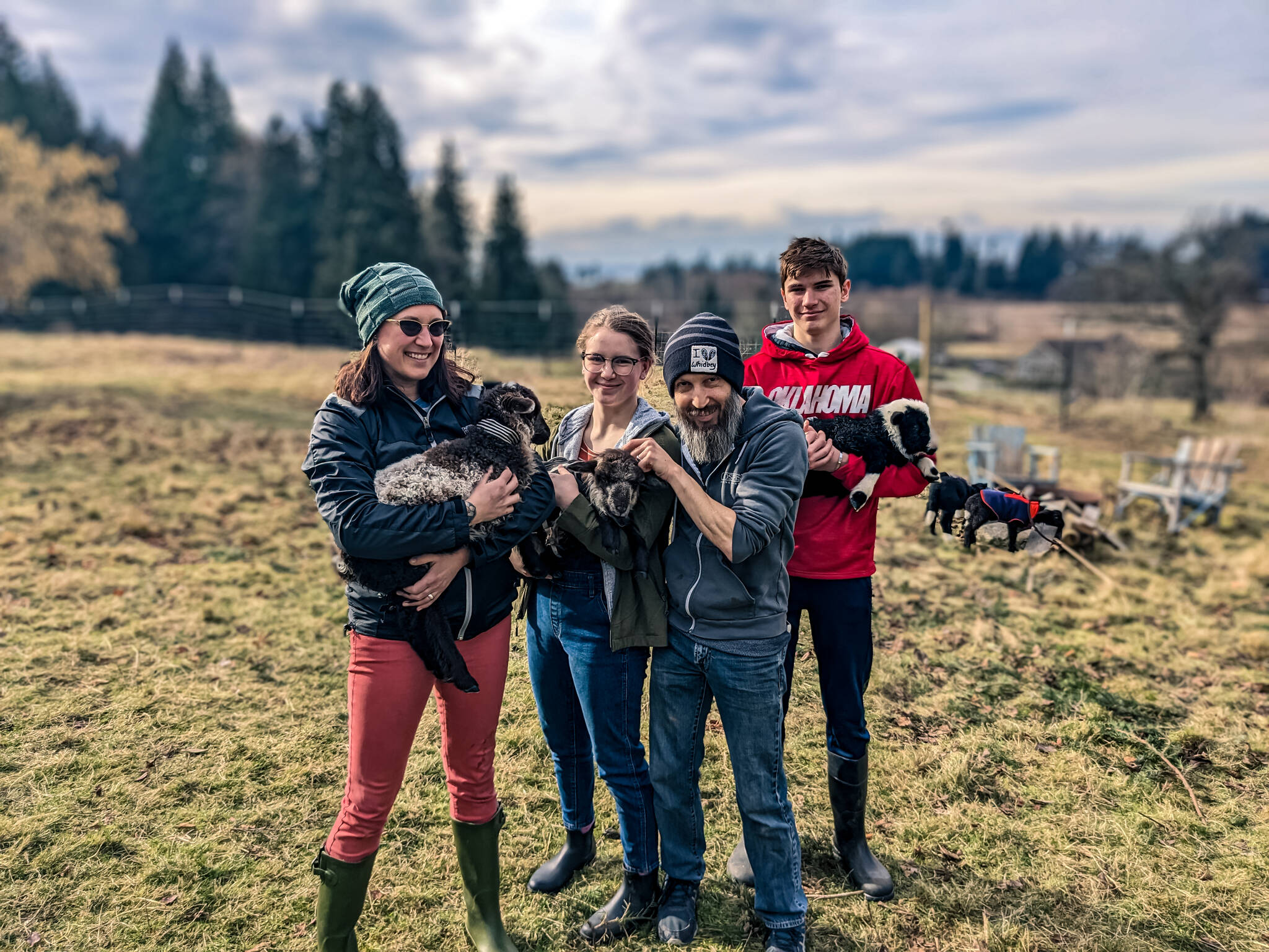 The Bell family adopted three rescue lambs from Ballydidean Farm Sanctuary this past spring. From left, Emily with Poppet, Zetta with Widget, Shaun and Tyson with Otis. (Photo provided)