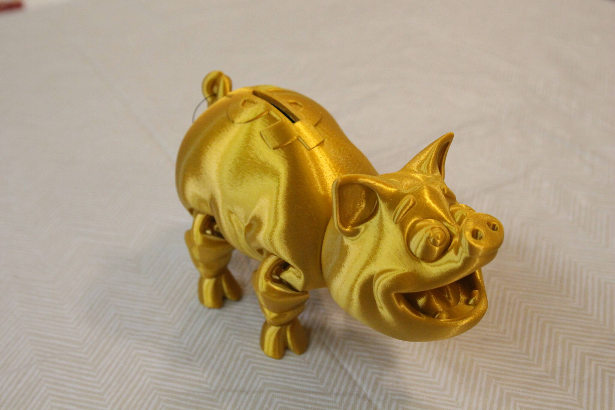 A 3D printed piggy bank, created by Gray Matter and available at Whidbey Island Crafter’s Market Studios, along with other 3D printed sculptures. (Photo by Luisa Loi)