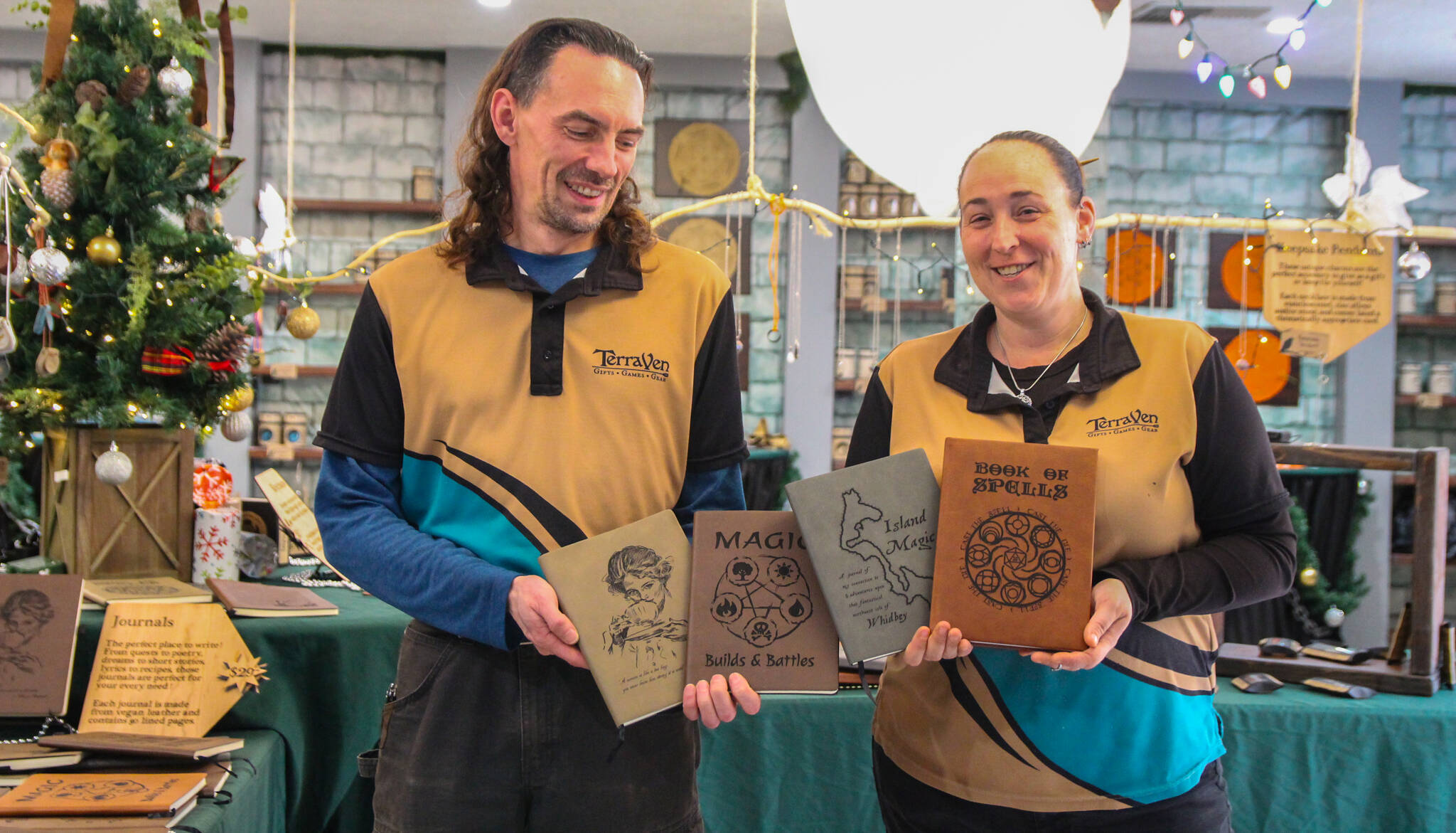 TerraVen owners Shea Looijen and Kristi Uhles hold some of the leather notebooks they designed. (Photo by Luisa Loi)