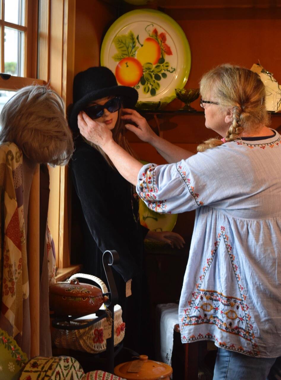 Heidi Norris adjusts sunglasses on Loretta, the mannequin mascot at the new Freeland shop, Whidbey Vintage Collective. (Photo by Patricia Guthrie)