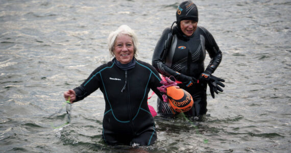 Photo by David Welton
Sharon Emerson and Kate Poss exit from their morning swim at the Langley marina