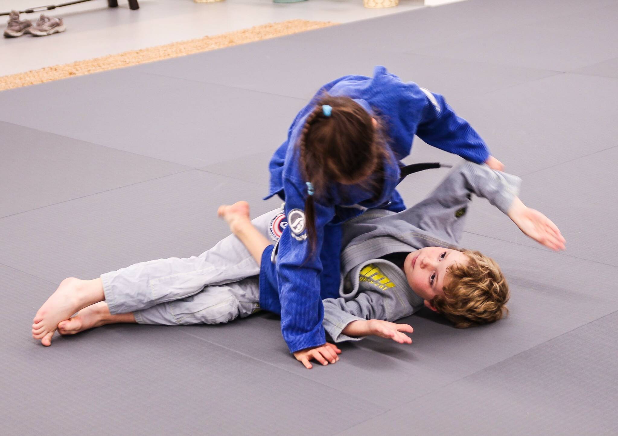 Two young athletes spar at Bold Spirit. According to owners and instructors Jorgi and Mychal Cohen, Brazilian Jiu-Jitsu teaches kids self-discipline and helps them build confidence. (Photo by Luisa Loi)