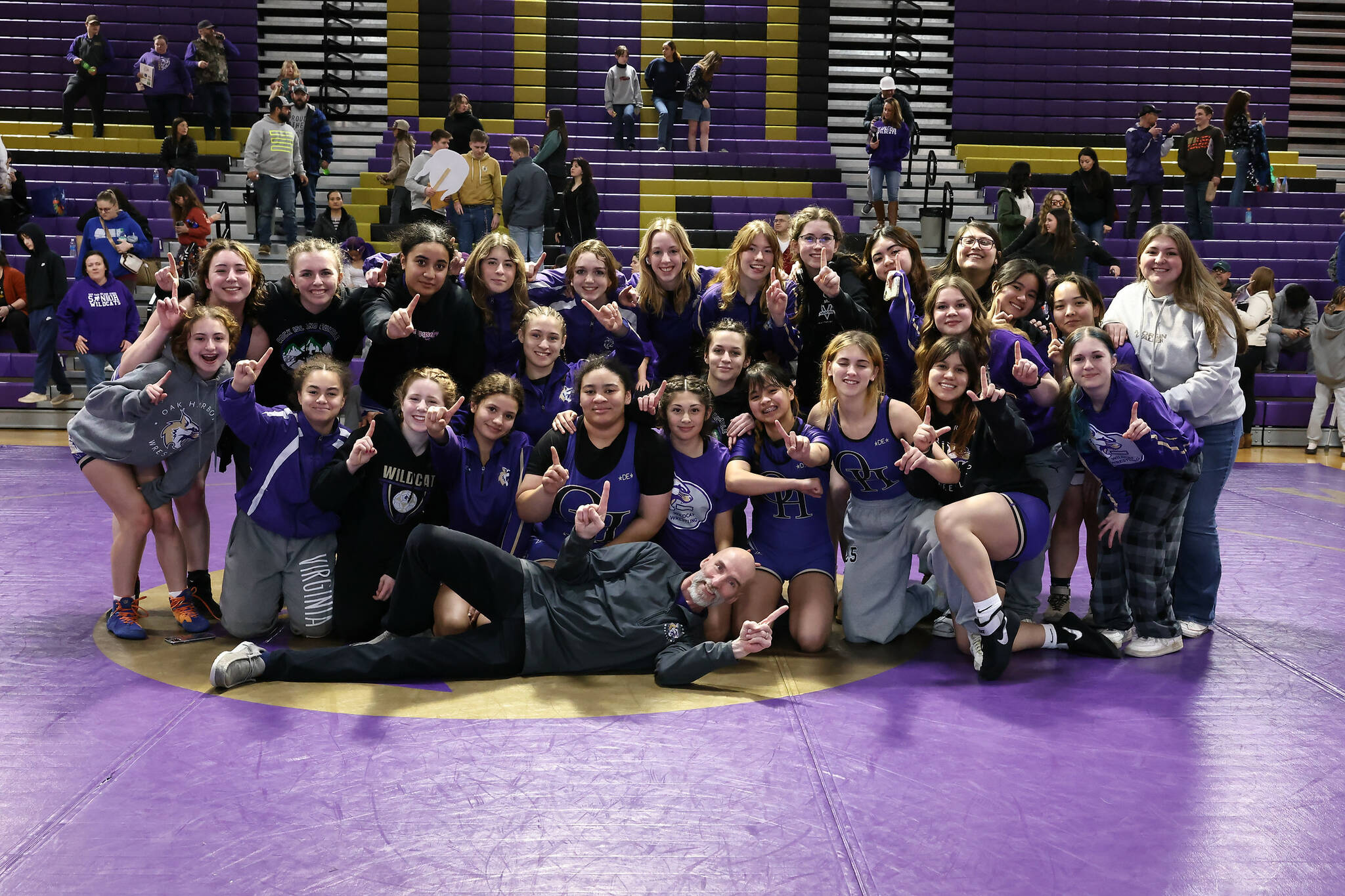Oak Harbor High School’s girls wrestling team celebrates winning the Northwest Conference championship Jan. 25. They are preparing to compete in the subregional tournament held this weekend at Oak Harbor High School. (Photo by John Fisken)