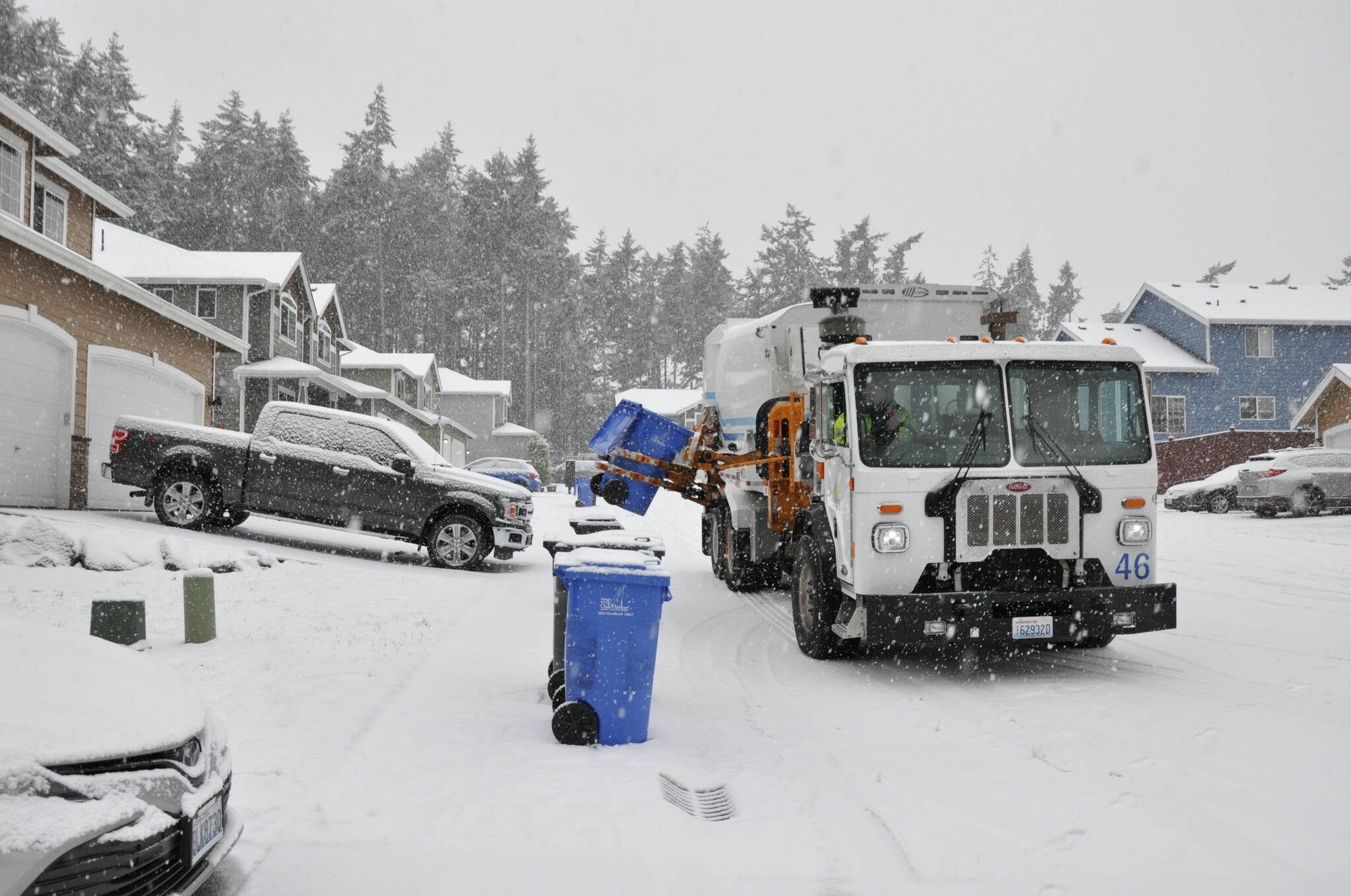 On January 18, 2024, Public Works Department staff George Place collects garbage and recycling from homes in Oak Harbor during the start of a snowstorm. (Photo courtesy of City of Oak Harbor Public Works)