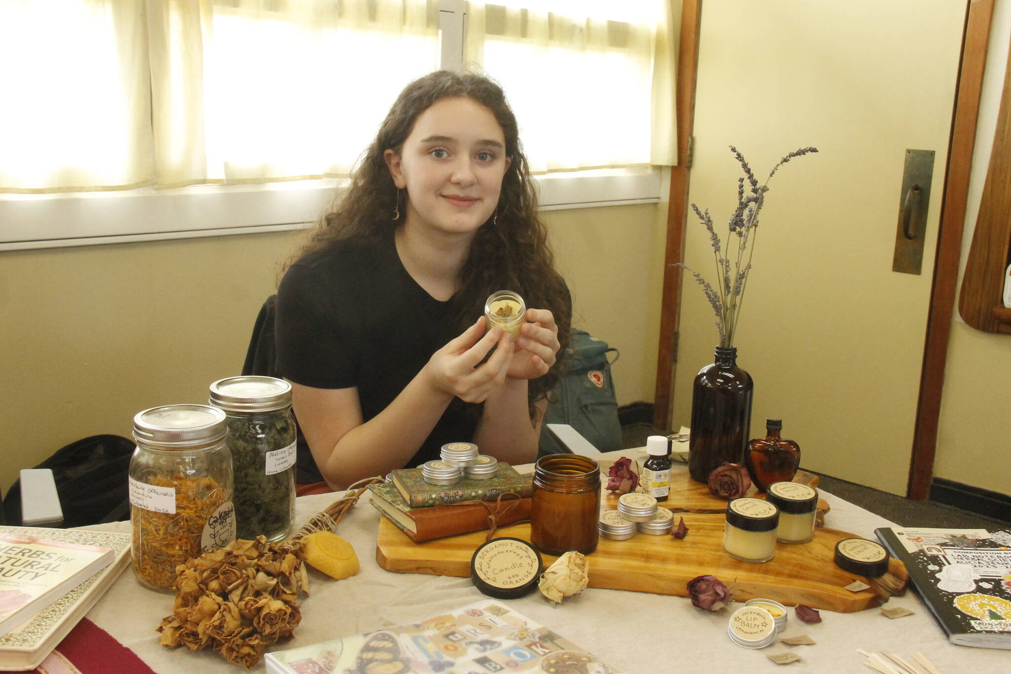 Tenth grader Alicia Jenkins made lemon balm lip balm, a salve for minor abrasions and a candle of orange and bergamot. (Photo by Kira Erickson/South Whidbey Record)