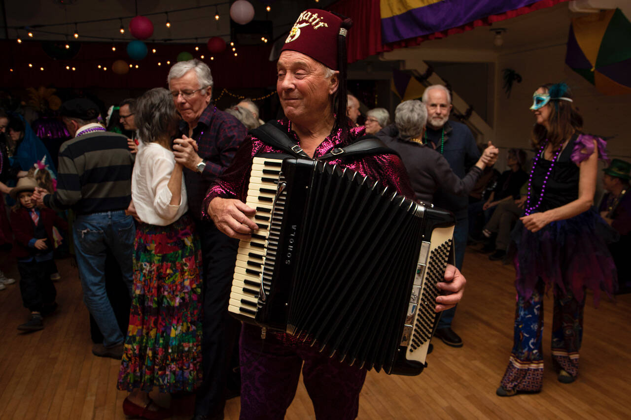 Ken Pickard plays an accordion during a past Mardi Gras party. (Photo by David Welton)