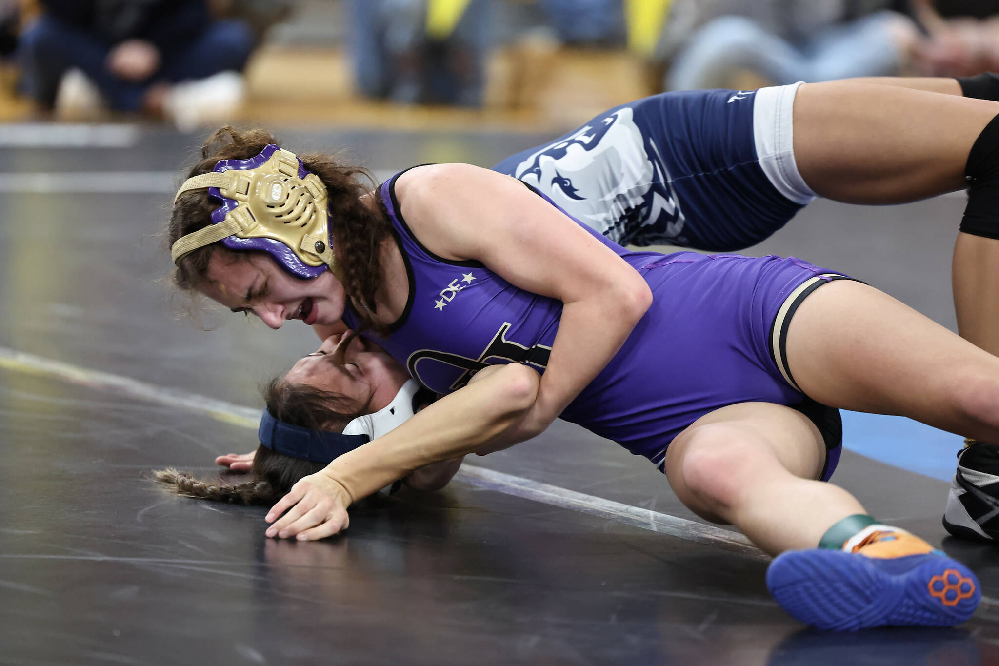 Oak Harbor’s Julia Gonzales tries to pin her opponent during the subregional tournament that took place last weekend at Oak Harbor High School. Gonzales placed first at 100 pounds and the Wildcats won the tournament. Photo by John Fisken.