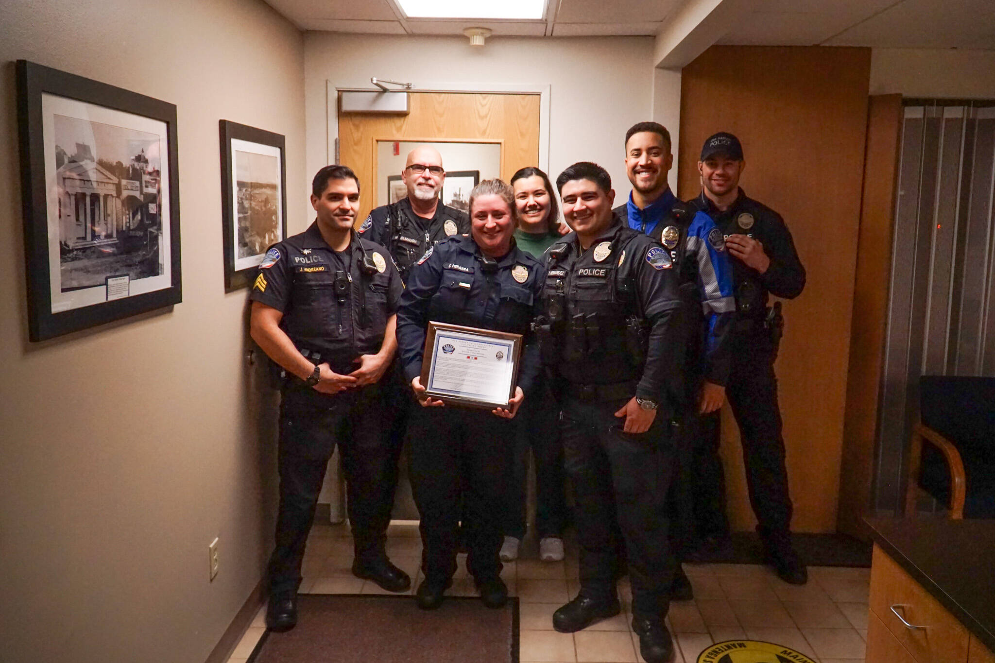 Members of the Oak Harbor police department show support to Officer Claire Herrera (middle), who earned the life saving award on Monday.