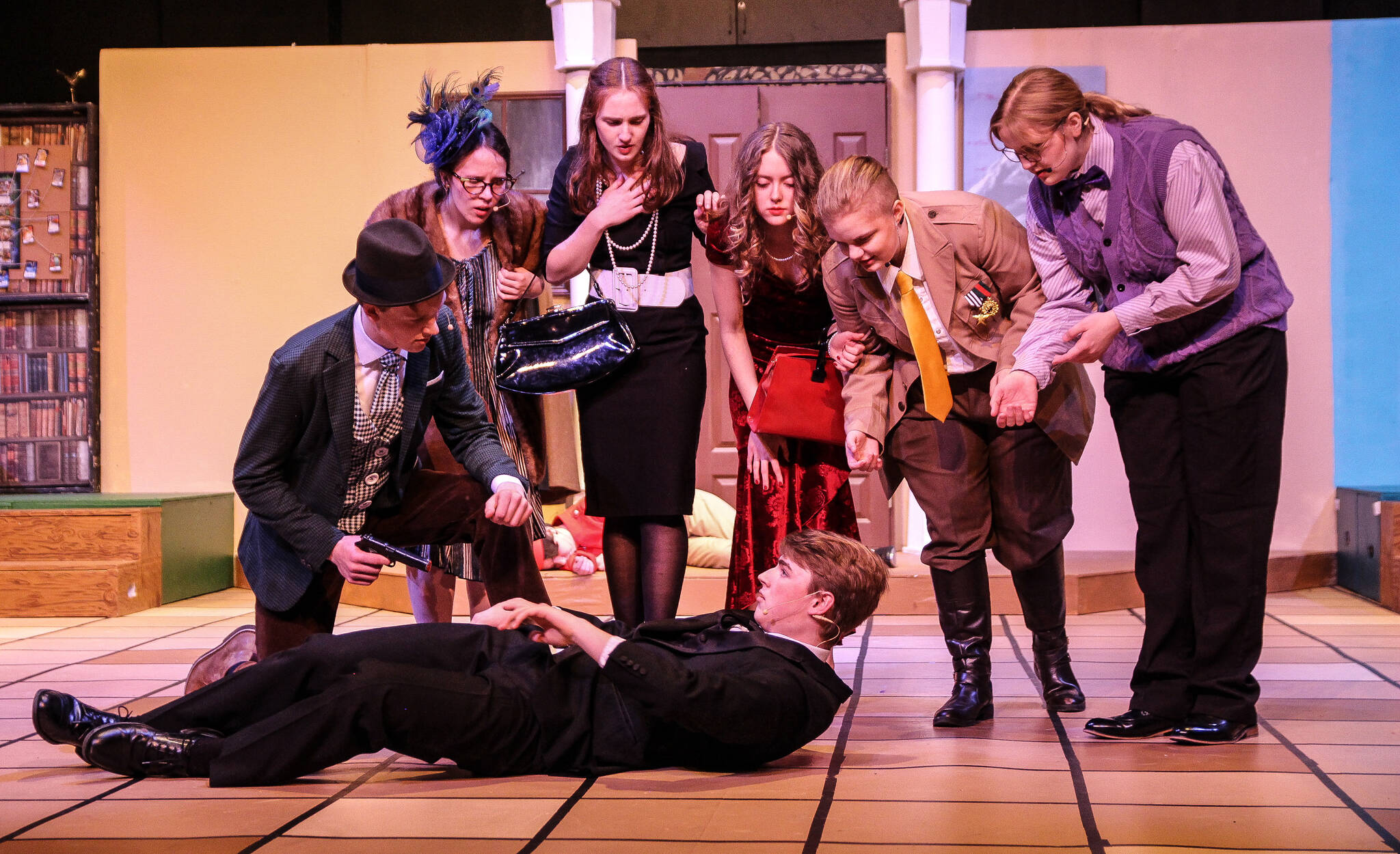 The mansion’s guests watch as Wadsworth (Spencer Grubbs) reacts dramatically to his injuries. (Photo by Luisa Loi)