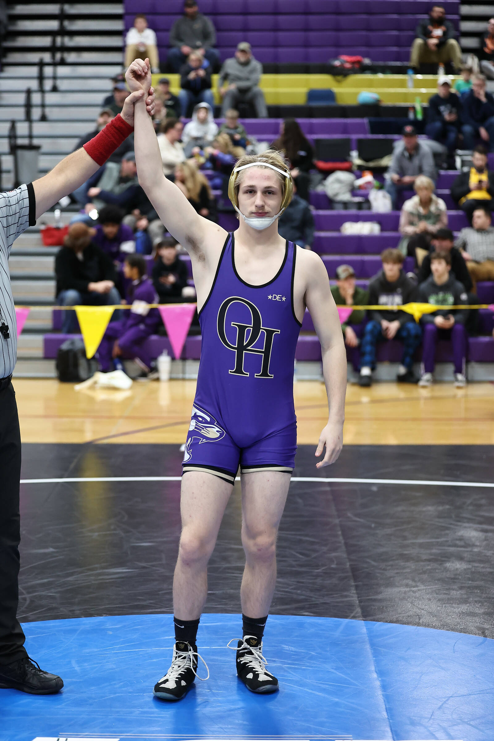 Oak Harbor’s Percie Hatfield has his hand raised in victory after a match during the regional tournament that took place Saturday at Oak Harbor High School. He placed first at 157 pounds and he will advance to the Mat Classic this weekend in Tacoma. (Photo by John Fisken)