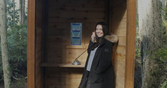 Photo by Kira Erickson/South Whidbey Record
Suzie Reynolds demonstrates how to use the new wind phone at Trustland Trails Park.
