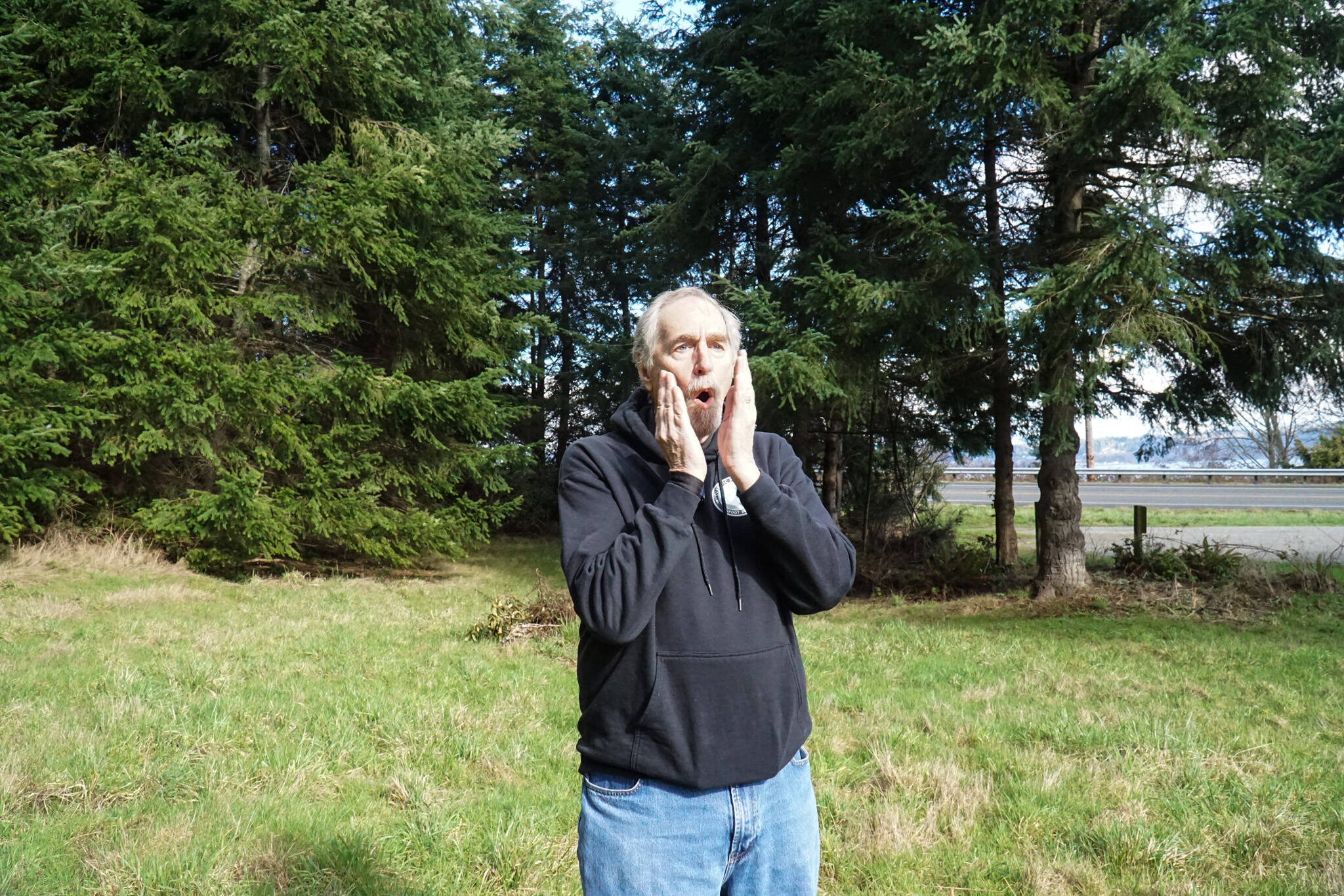 Whidbey bigfoot researcher David Ellis emulated a tree knock with his mouth outside Langley (photo by Sam Fletcher)