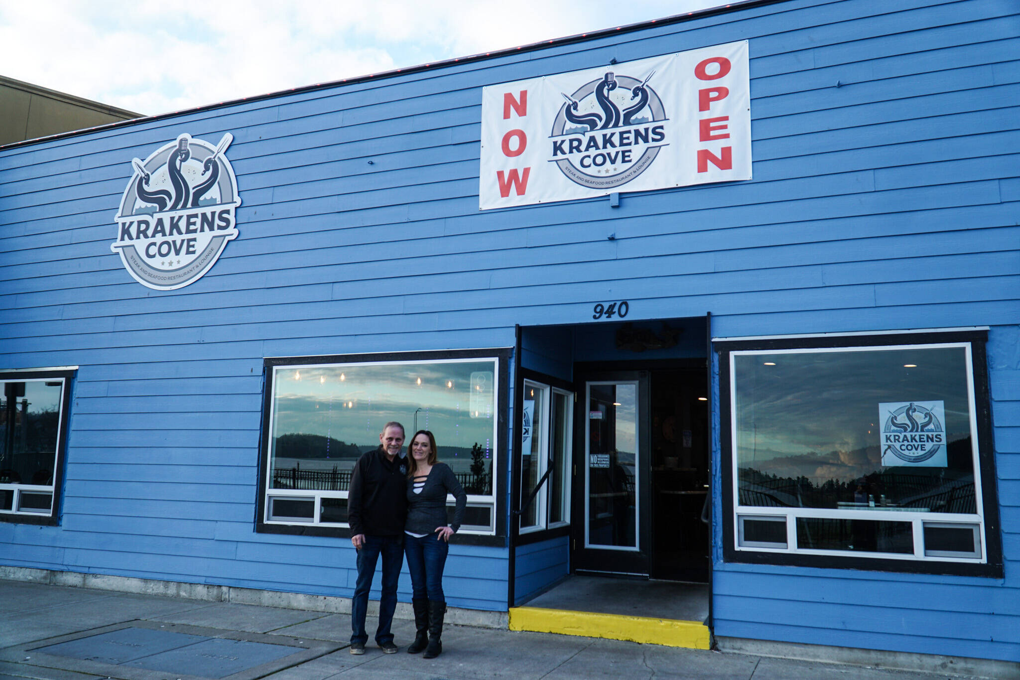 Co-owners Kevin (left) and Megan Collins (right) pose in front of Kraken's Cove in Oak Harbor. (Photo by Sam Fletcher)