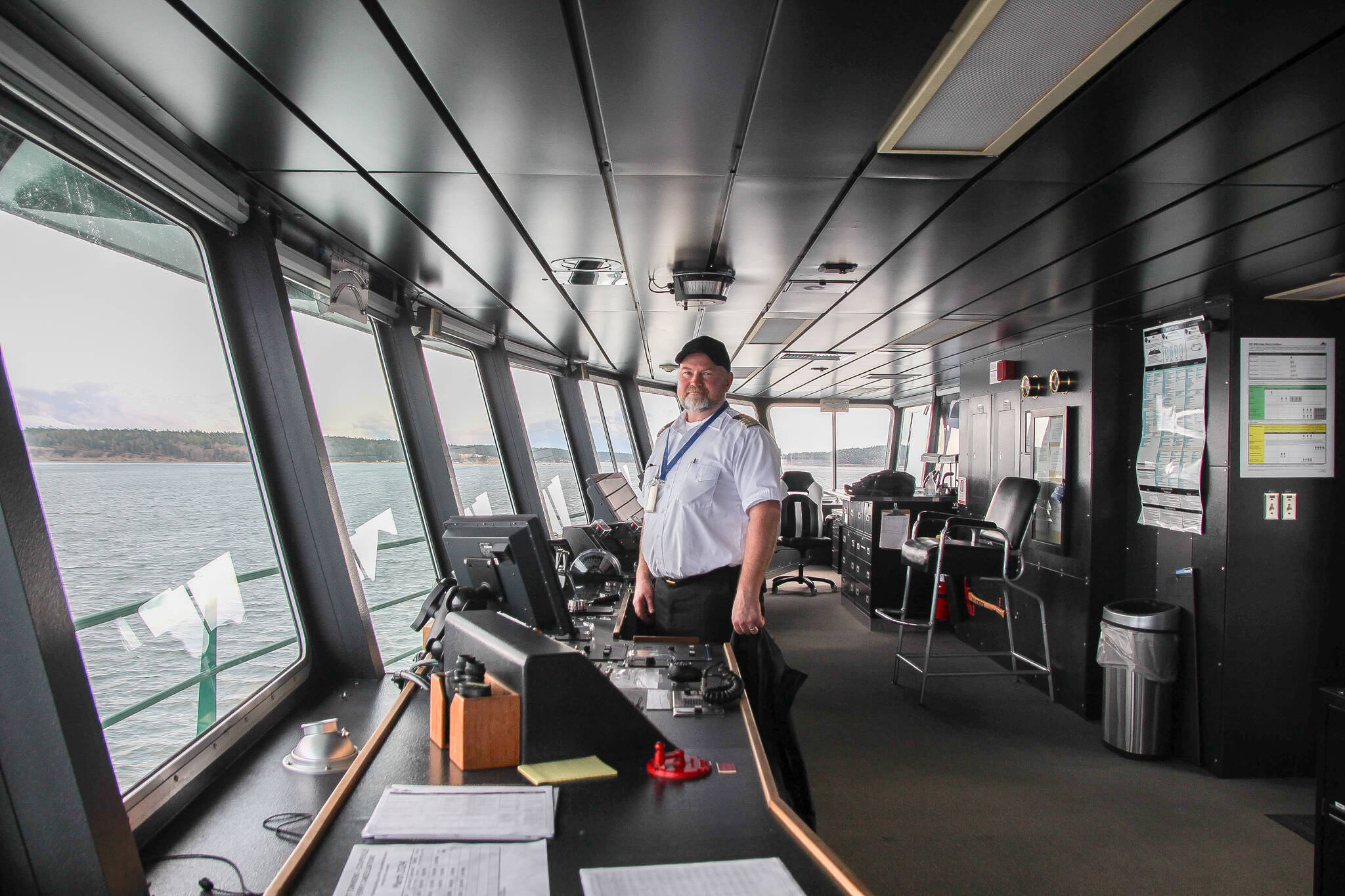 Captain Mark Gripp smiles surrounded by the displays and controls in the Kennewick’s pilothouse, moments before leaving Keystone Harbor. (Photo by Luisa Loi)