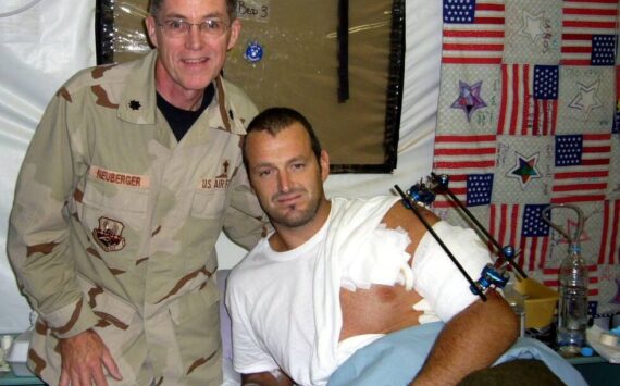 Photo courtesy of Jeffrey Neuberger
Chaplain, Lt Col, USAF (Ret) Jeffrey Neuberger stands with a wounded soldier, Gareth Evans, in Iraq.