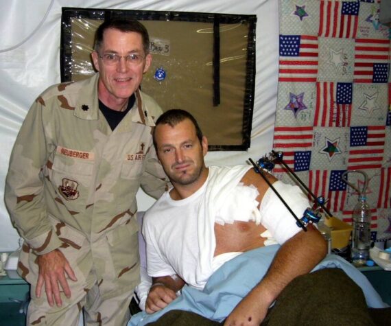 <p>Photo courtesy of Jeffrey Neuberger</p>
                                <p>Chaplain, Lt Col, USAF (Ret) Jeffrey Neuberger stands with a wounded soldier, Gareth Evans, in Iraq.</p>