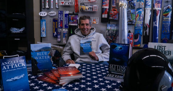 Whidbey author Peter Hunt showcasing his books at the Pacific Northwest Naval Air Museum on Thursday (Photo by Sam Fletcher)